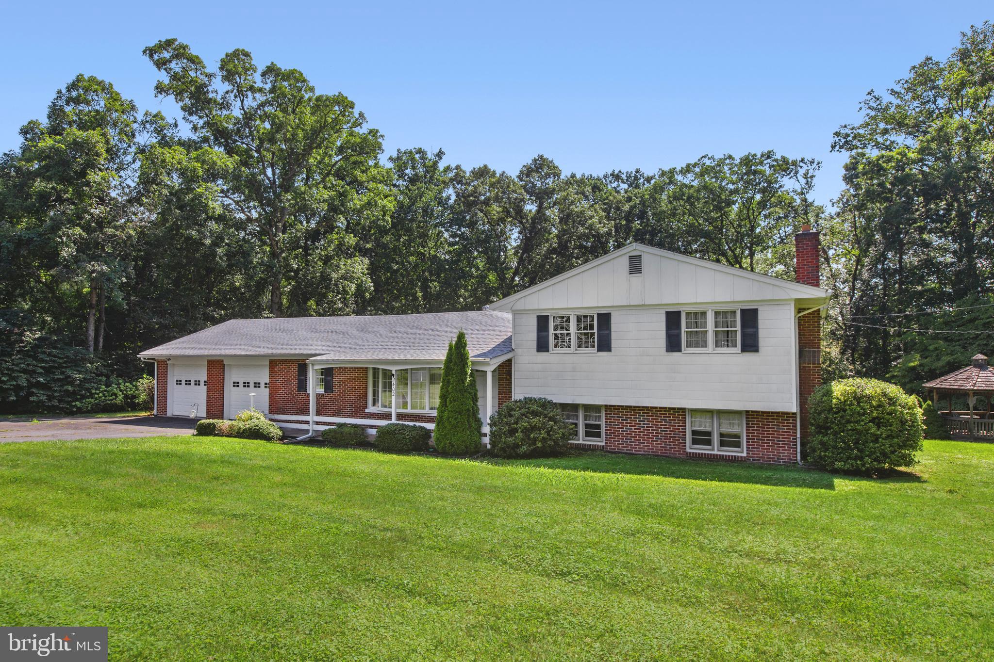 a view of a house with a yard and trees