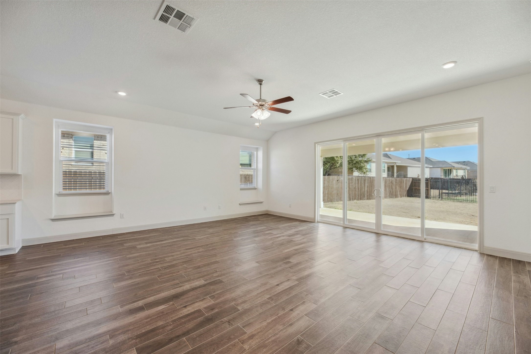 1736 Weavers Bend Georgetown, TX 78628 - Photo 14 of 40 A wall of windows and sliding doors floods the home with natural light, enhancing its tranquil ambiance.