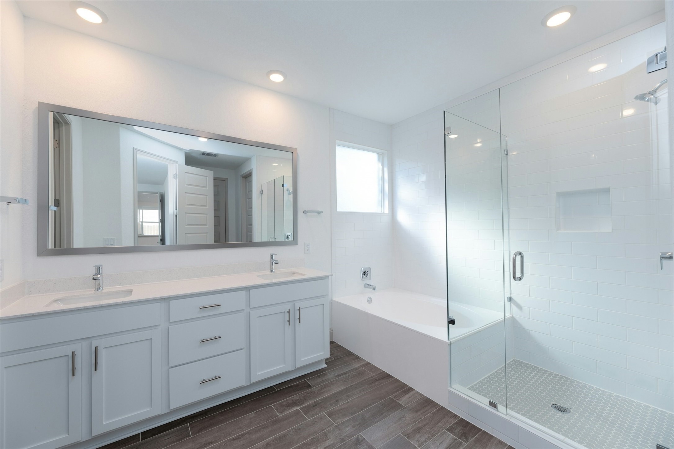 1736 Weavers Bend Georgetown, TX 78628 - Photo 19 of 40 The spa-inspired ensuite features a dual vanity, a luxurious soaking tub, and a frameless glass shower with designer tile surround. A spacious walk-in closet completes this private retreat.