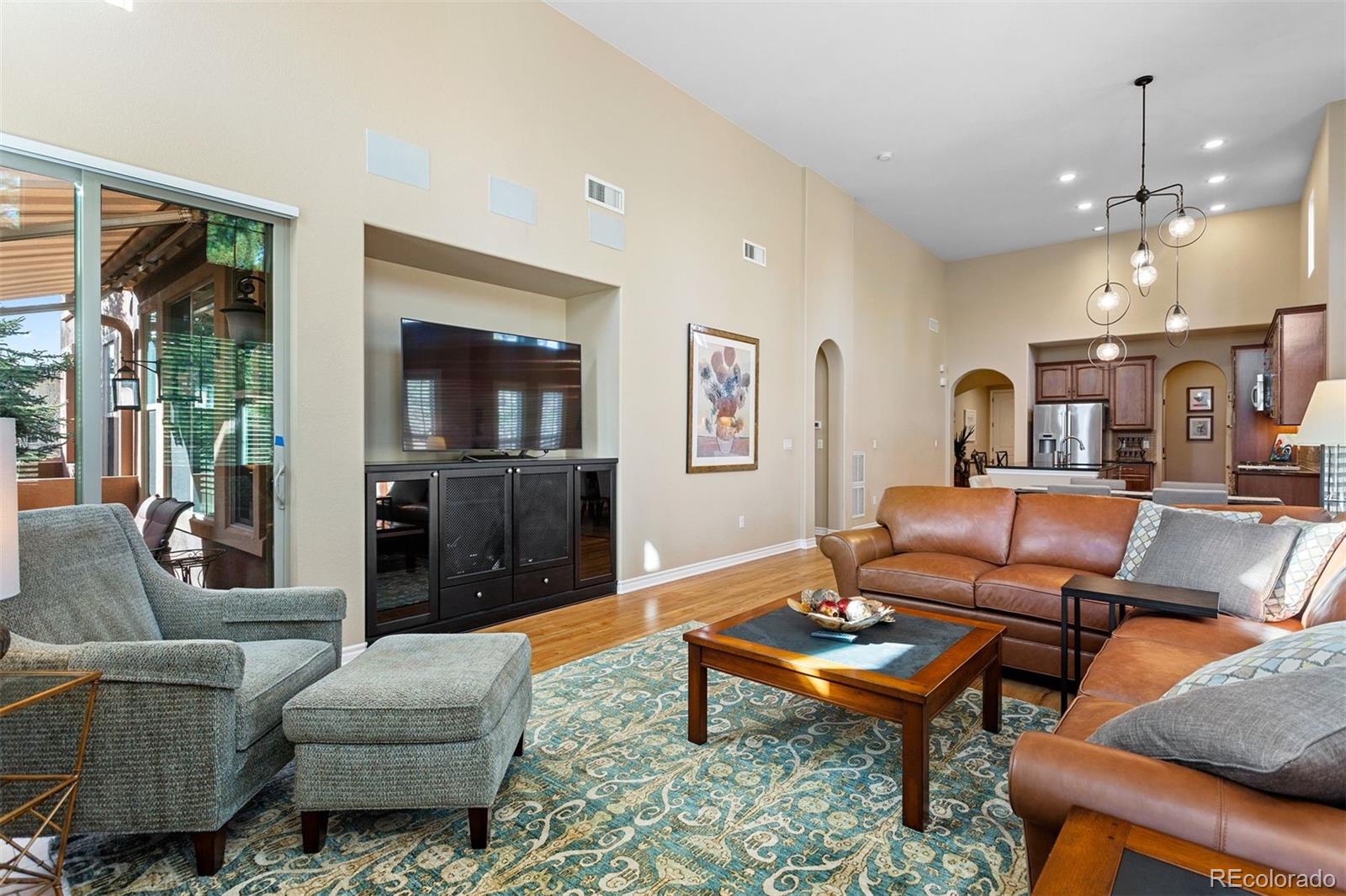 9236 Viaggio Way Highlands Ranch, CO 80126 - Photo 20 of 41 a living room with furniture and a flat screen tv