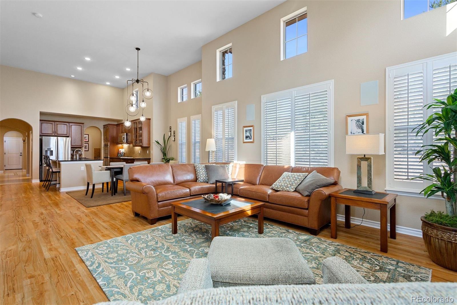 9236 Viaggio Way Highlands Ranch, CO 80126 - Photo 21 of 41 a living room with furniture wooden floor and a table