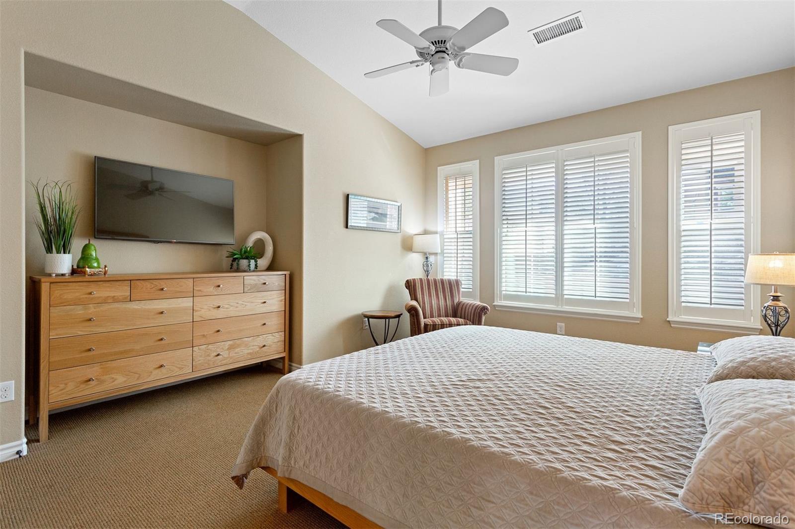 9236 Viaggio Way Highlands Ranch, CO 80126 - Photo 25 of 41 a bedroom with a bed and a flat screen tv
