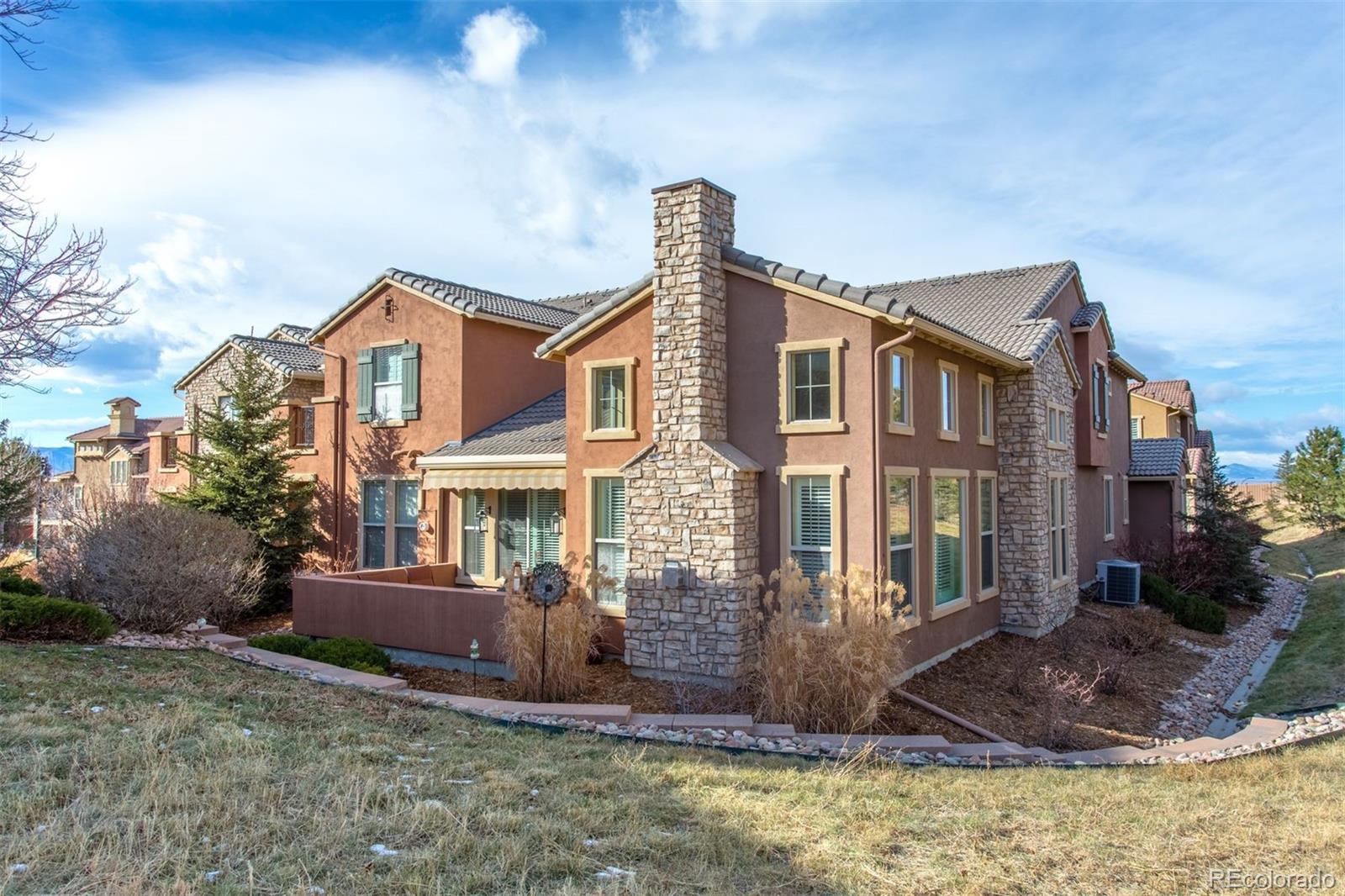 9236 Viaggio Way Highlands Ranch, CO 80126 - Photo 3 of 41 a front view of a house with a yard