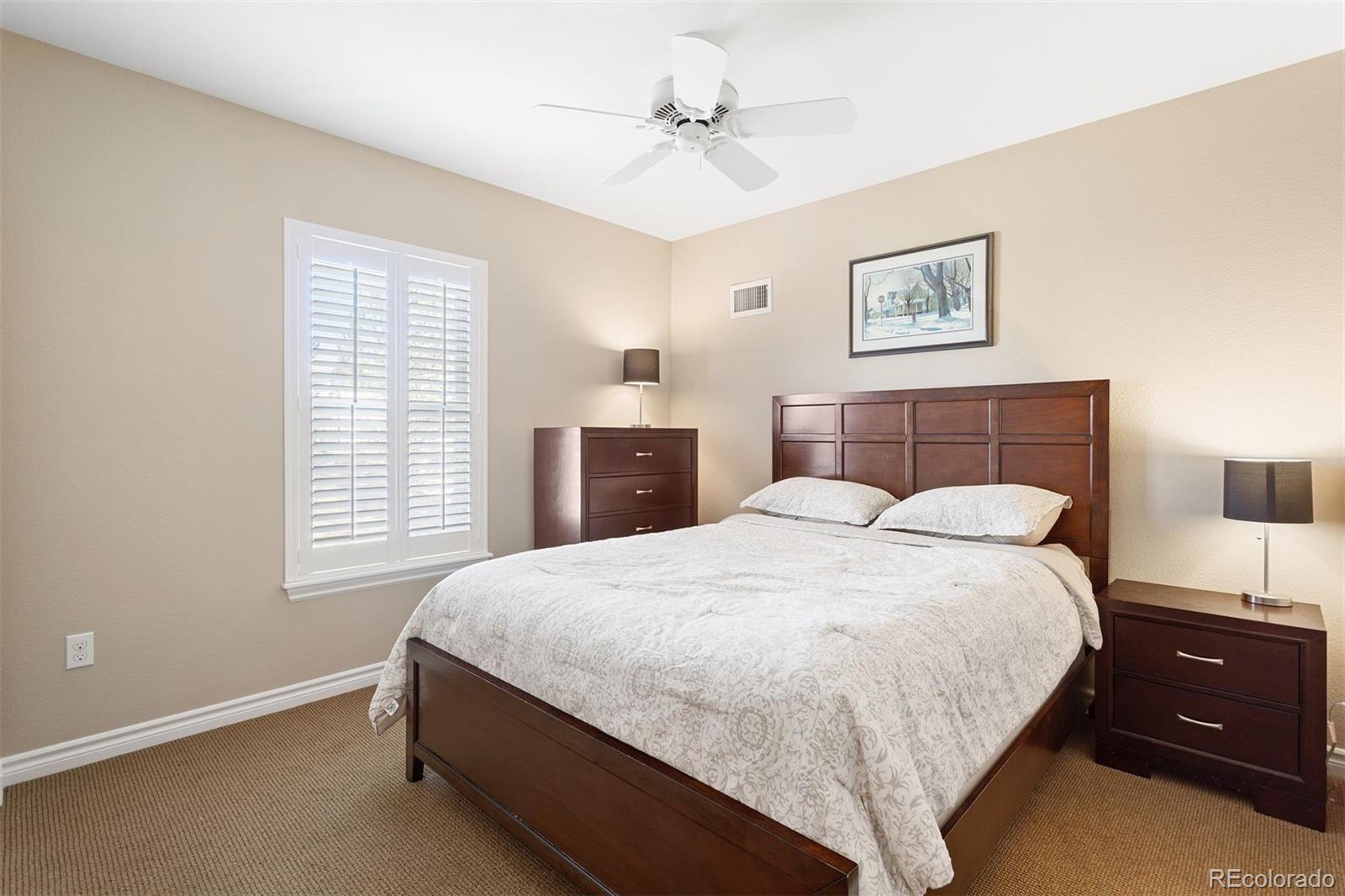 9236 Viaggio Way Highlands Ranch, CO 80126 - Photo 32 of 41 a bedroom with a bed and a lamp