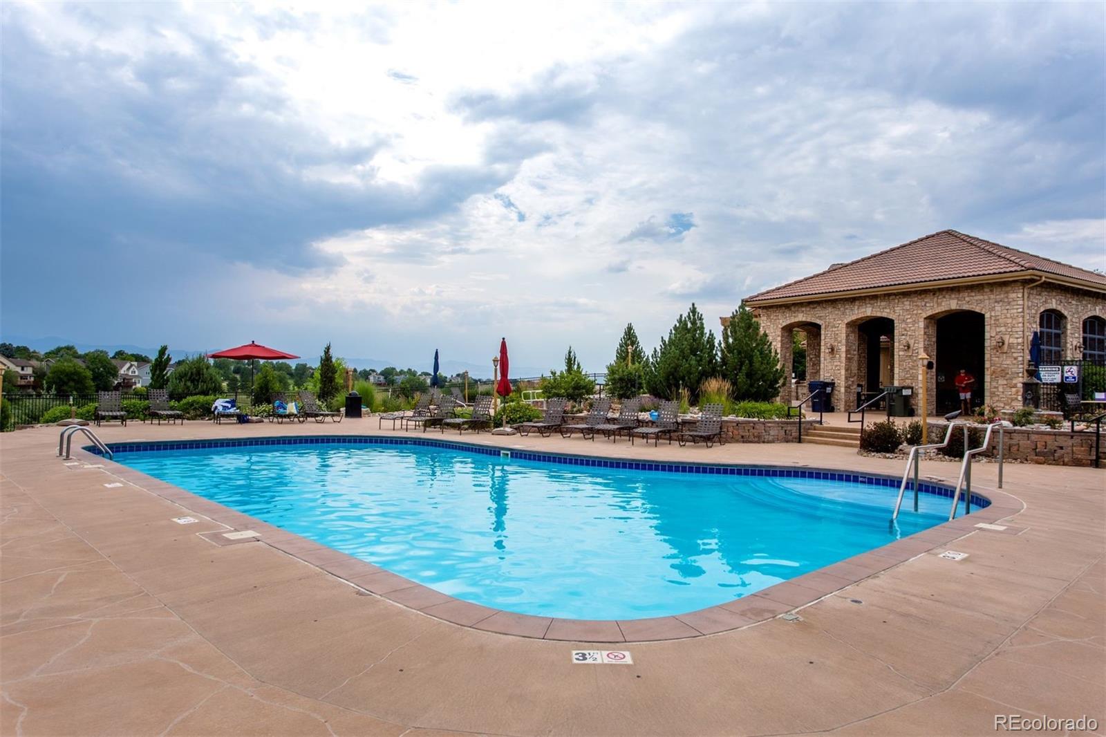 9236 Viaggio Way Highlands Ranch, CO 80126 - Photo 38 of 41 a view of a swimming pool with a table and chairs in patio