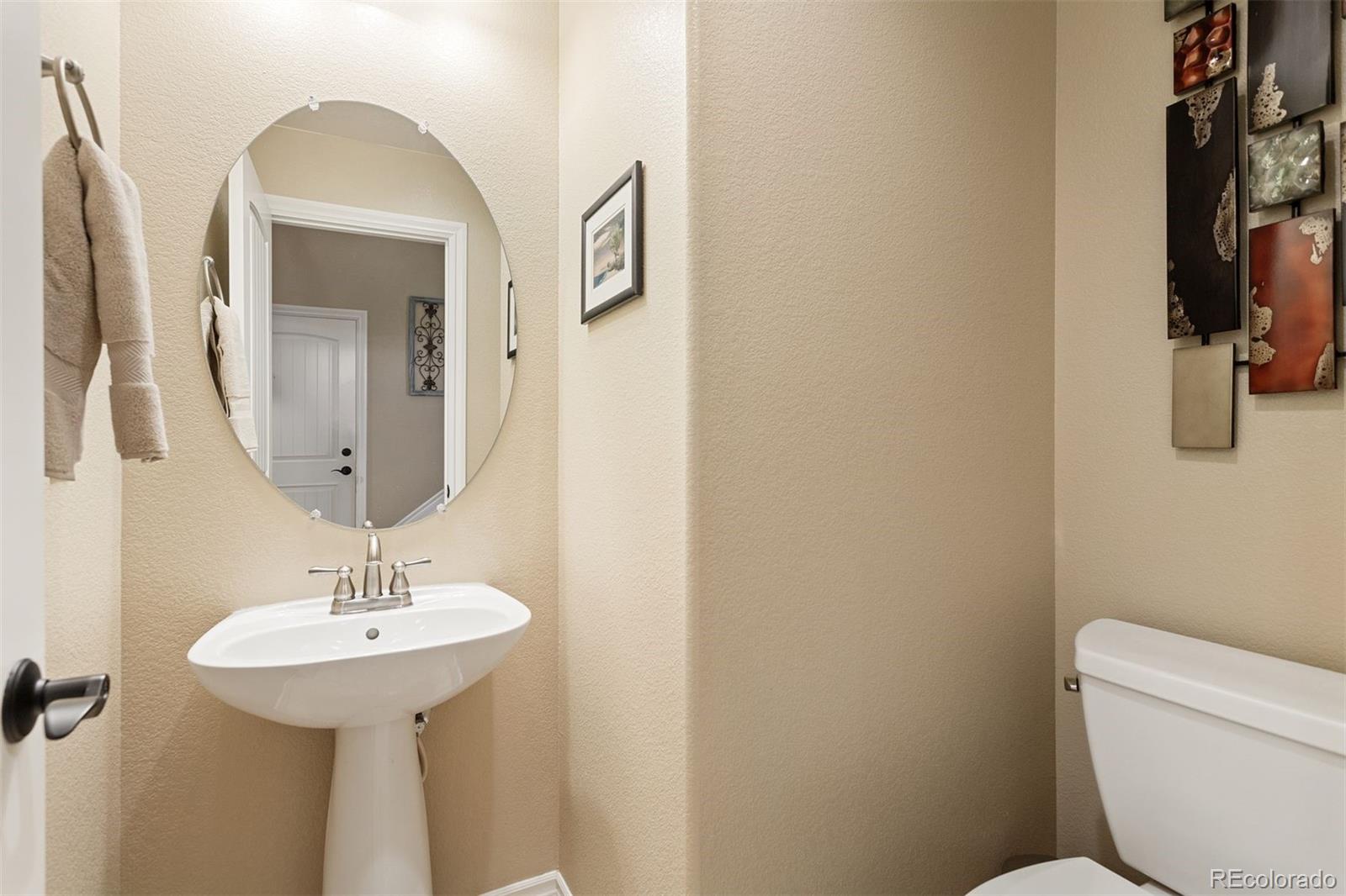 9236 Viaggio Way Highlands Ranch, CO 80126 - Photo 8 of 41 a bathroom with a toilet sink and mirror
