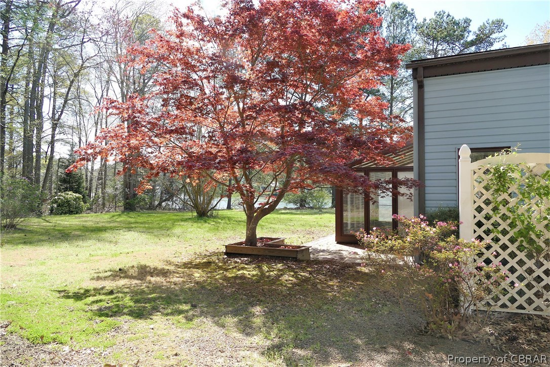 895 Holly Point Road Mathews, VA 23109 - Photo 11 of 47 a view of a house with a yard