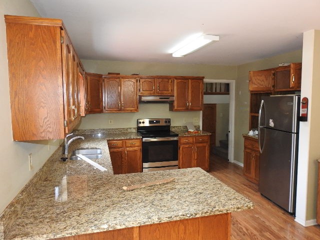 3557 Mahlon Moore Road Spring Hill, TN 37174 - Photo 13 of 29 a kitchen with stainless steel appliances granite countertop a refrigerator stove and oven