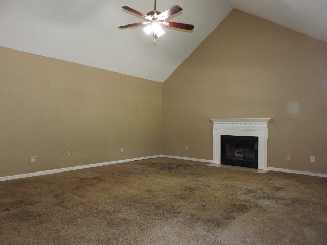 3557 Mahlon Moore Road Spring Hill, TN 37174 - Photo 7 of 29 an empty room with chandelier fan and fireplace