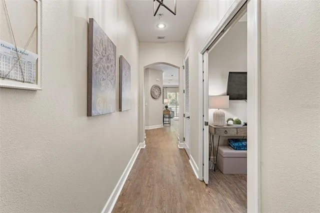 a dining room with furniture a chandelier and wooden floor