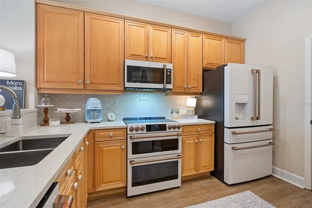 a bedroom with a bed and a flat tv screen on dresser