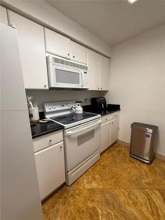 a view of a refrigerator in it and kitchen