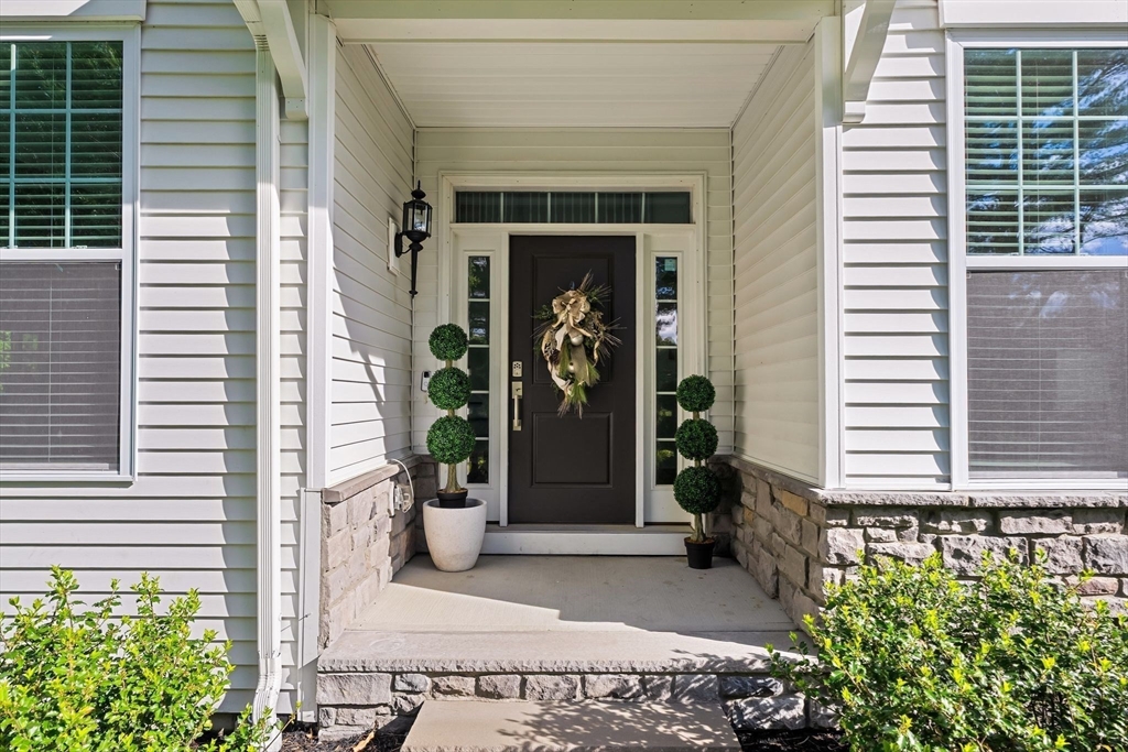 2 Hummingbird Way, Unit 1 Methuen, MA 01844 - Photo 3 of 42 a front view of a house with a potted plant and a window
