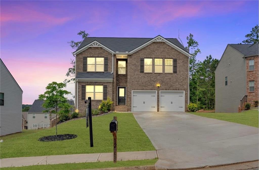 a front view of a house with a yard