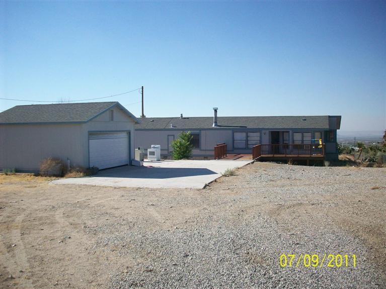 568 Smoke Tree Road Pinon Hills, CA 92372 - Photo 1 of 1 a view of a house with a yard and garage
