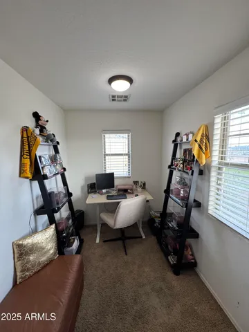 a bedroom with a bed a couch and dresser