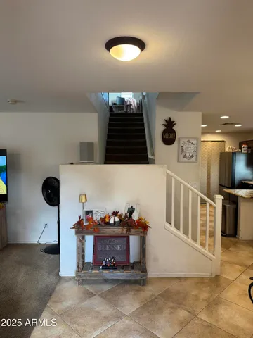 a kitchen with granite countertop a refrigerator and a stove top oven