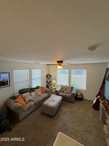 a living room with furniture and a mirror