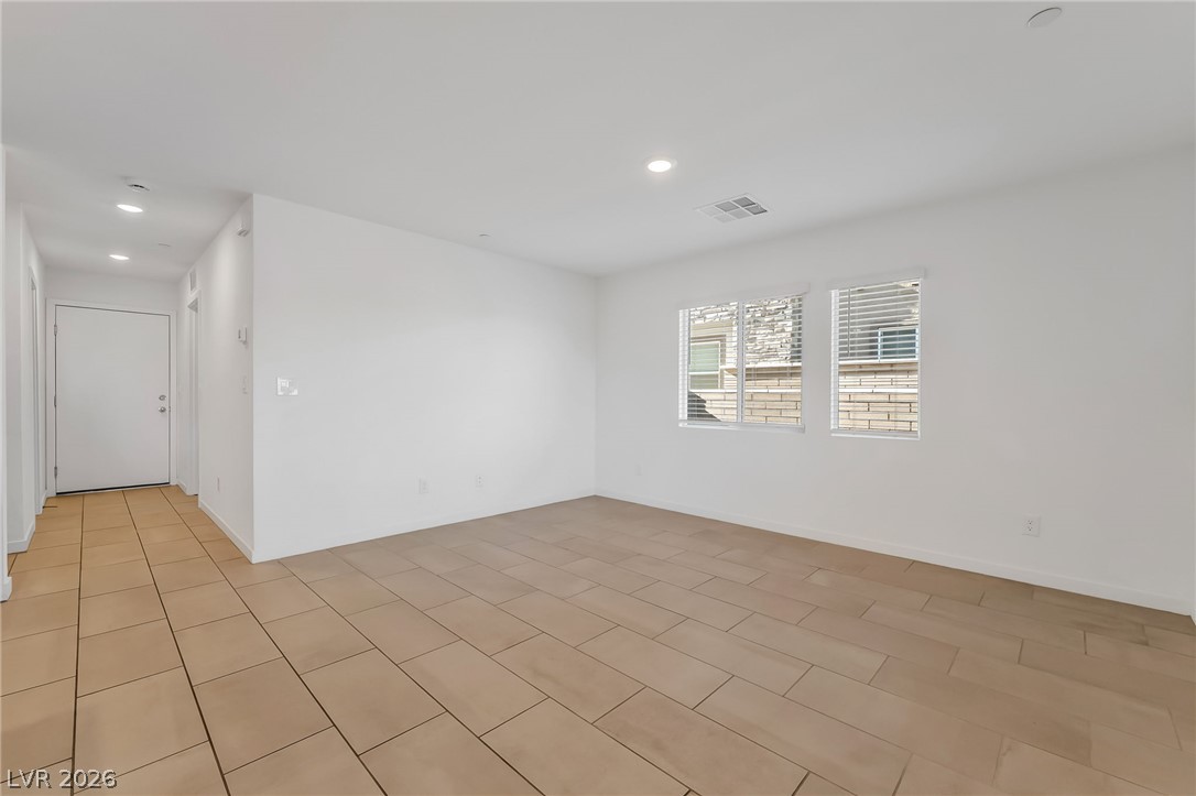 894 Cadence View Way Henderson, NV 89011 - Photo 5 of 23 A well-lit interior space with sleek tile flooring and ample natural illumination from multiple windows.