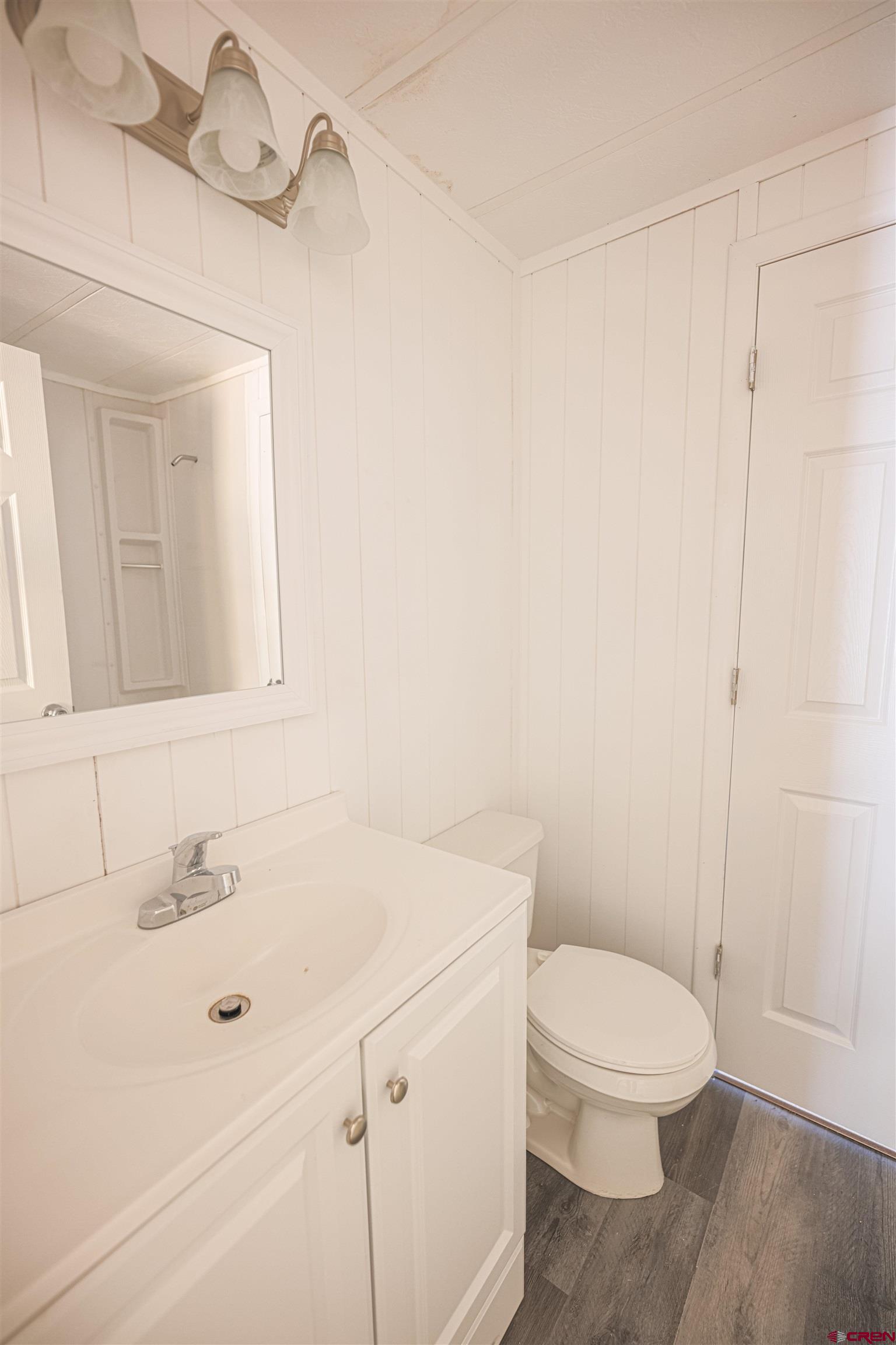 11 Rickey Place Monte Vista, CO 81144 - Photo 18 of 20 a white toilet sitting next to a bathroom sink