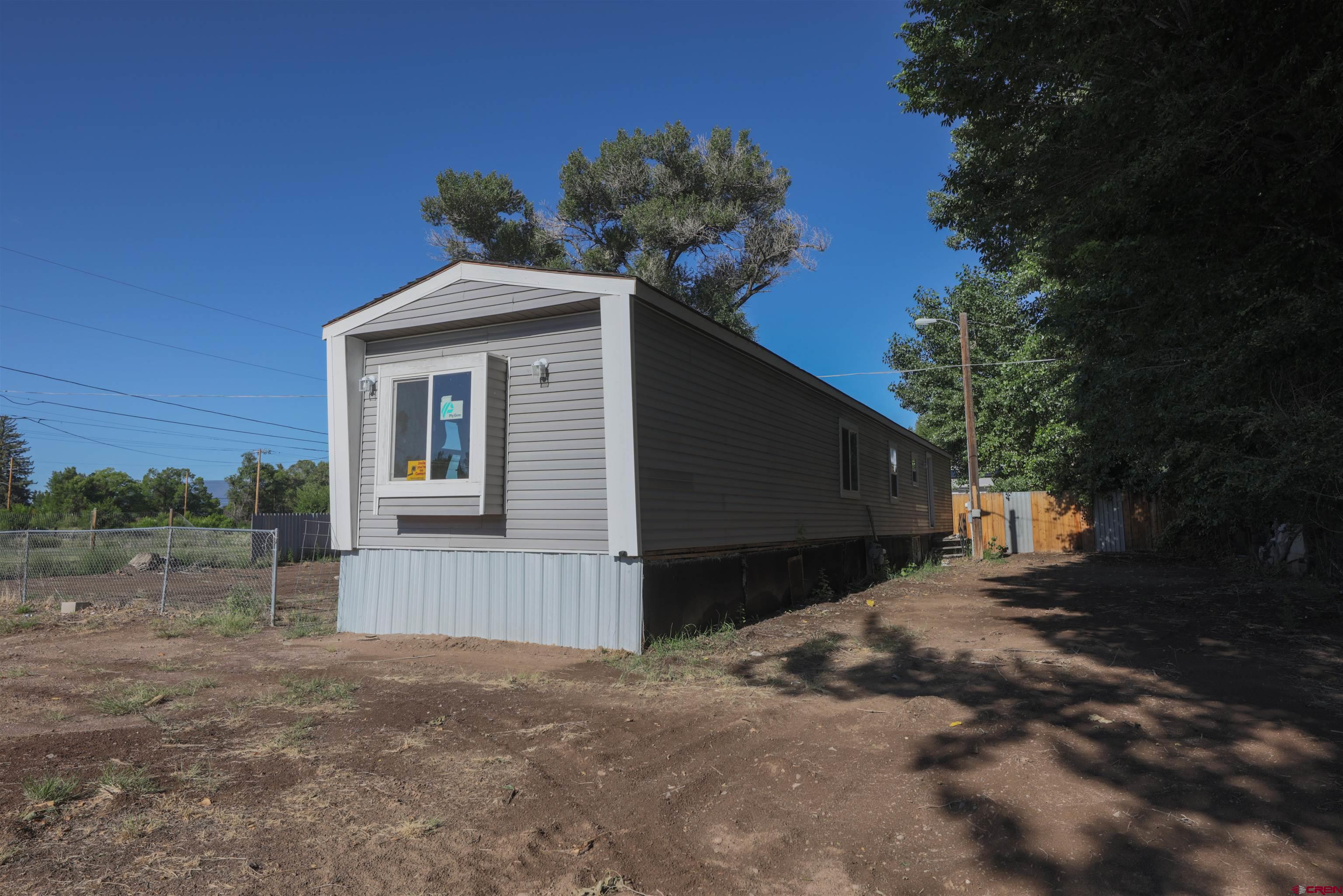 11 Rickey Place Monte Vista, CO 81144 - Photo 2 of 20 a front view of a house with a yard and garage
