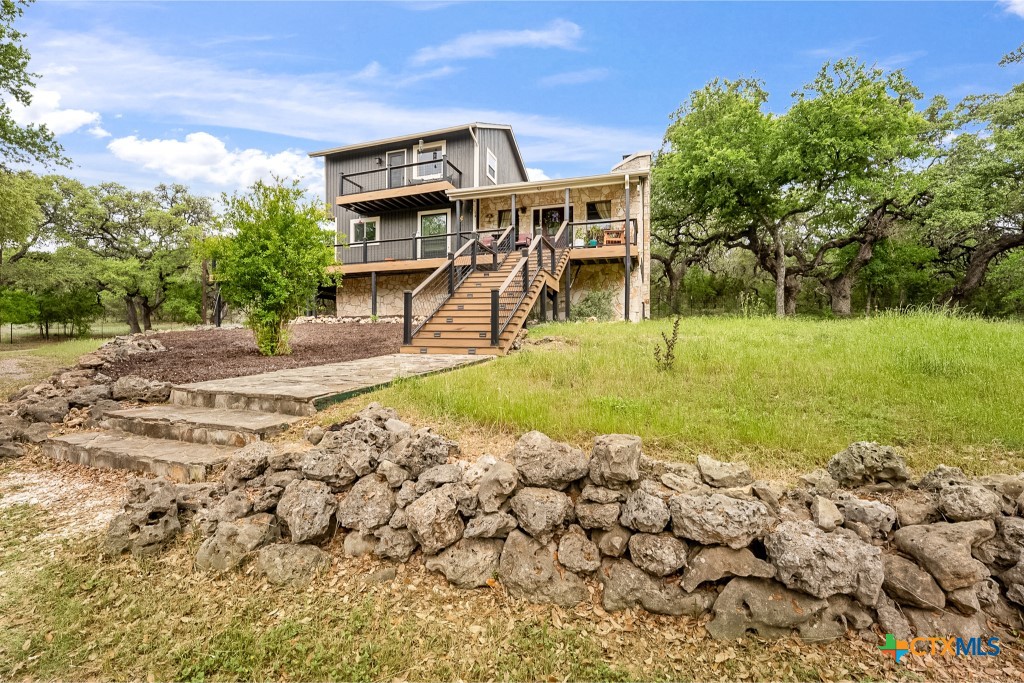 805 Sunrise Trail Spring Branch, TX 78070 - Photo 2 of 25 a front view of a house with a yard