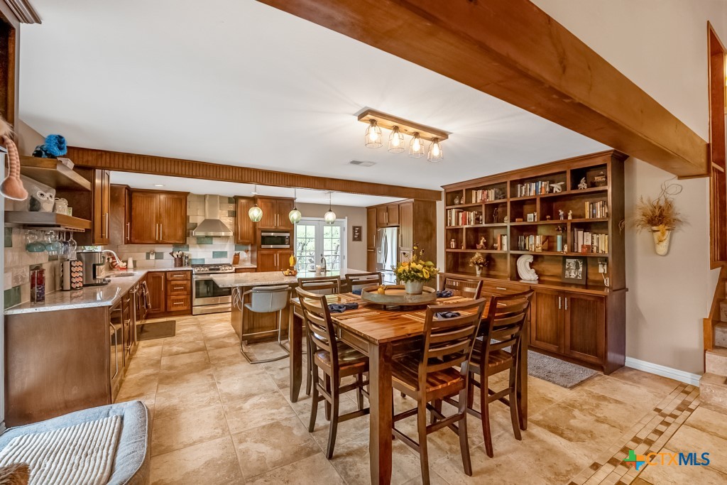 805 Sunrise Trail Spring Branch, TX 78070 - Photo 4 of 25 a view of a dining room with furniture and chandelier