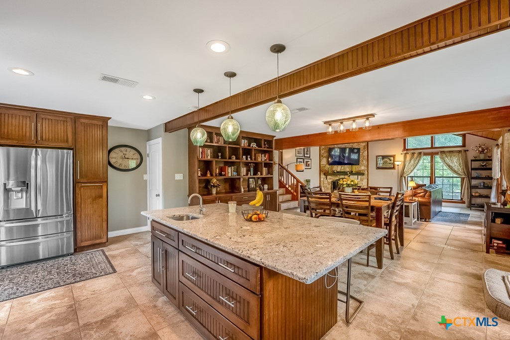 805 Sunrise Trail Spring Branch, TX 78070 - Photo 8 of 25 a living room with stainless steel appliances furniture a chandelier and a kitchen view