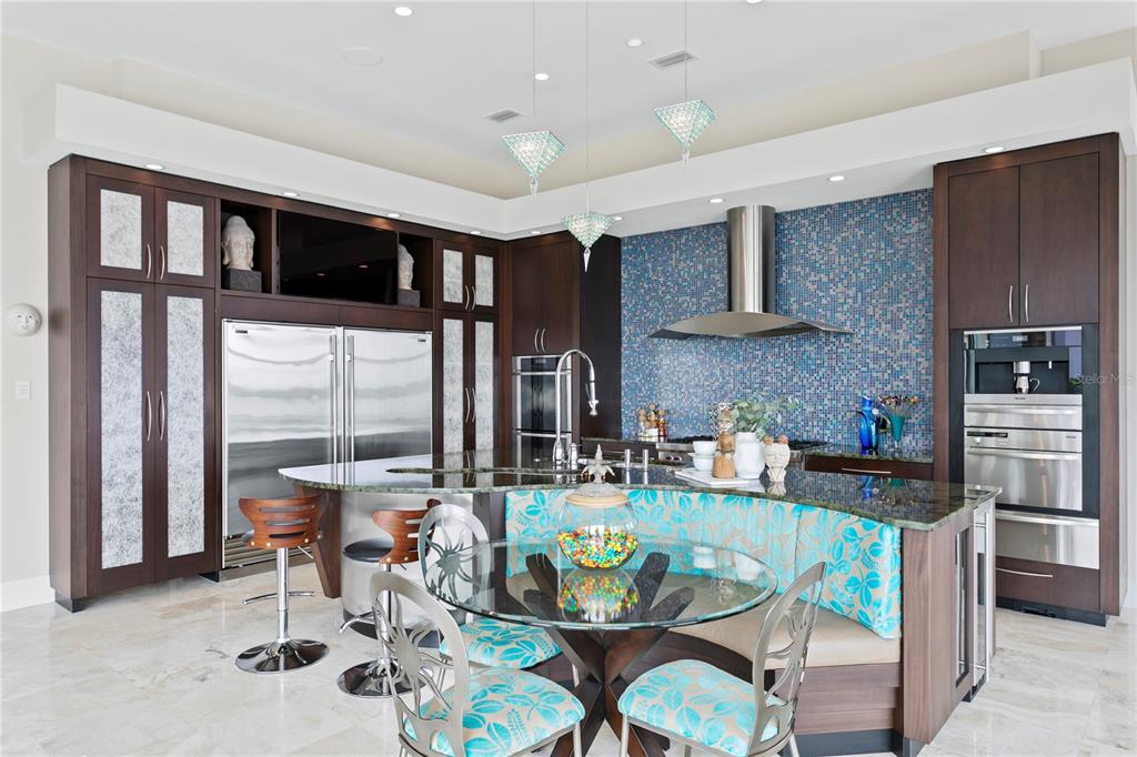 2279 Mermaid Point Northeast St. Petersburg, FL 33703 - Photo 25 of 100 a dining room with furniture a floor to ceiling window and potted plants