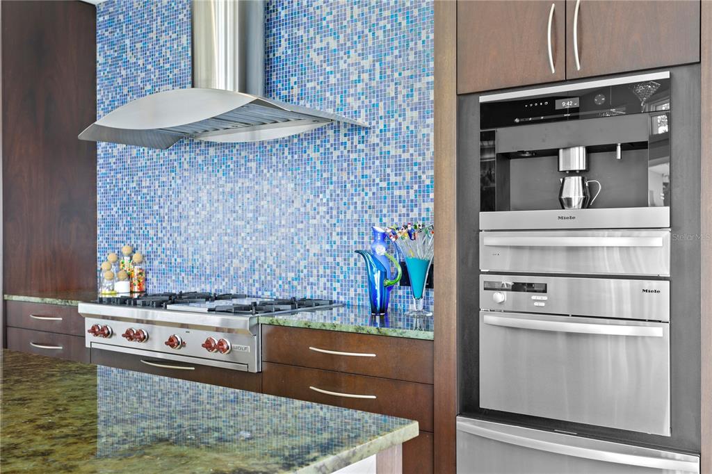 2279 Mermaid Point Northeast St. Petersburg, FL 33703 - Photo 26 of 100 a kitchen with stainless steel appliances granite countertop a stove and a wooden cabinets