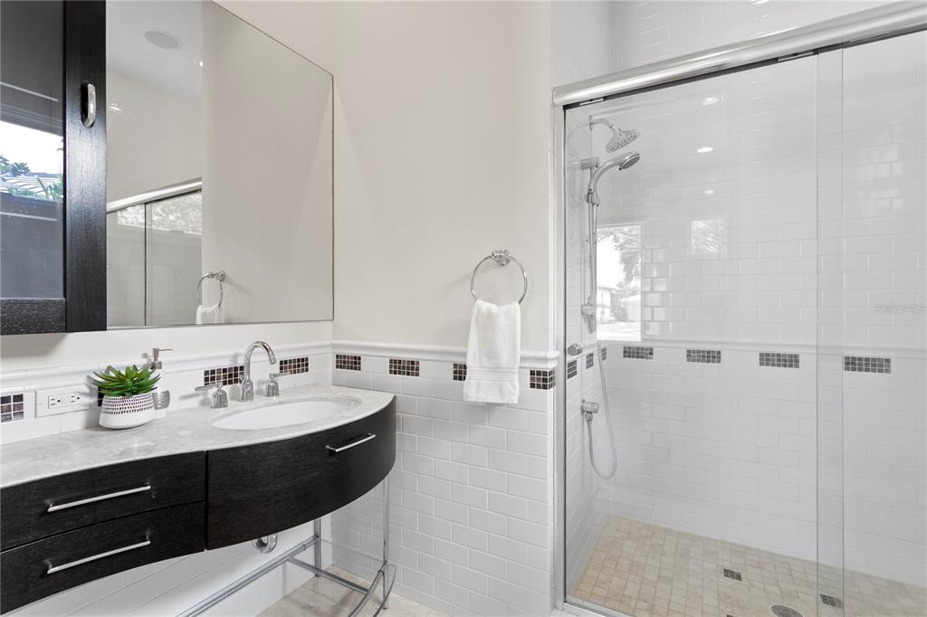 2279 Mermaid Point Northeast St. Petersburg, FL 33703 - Photo 44 of 100 a en suite bathroom with a sink and a mirror