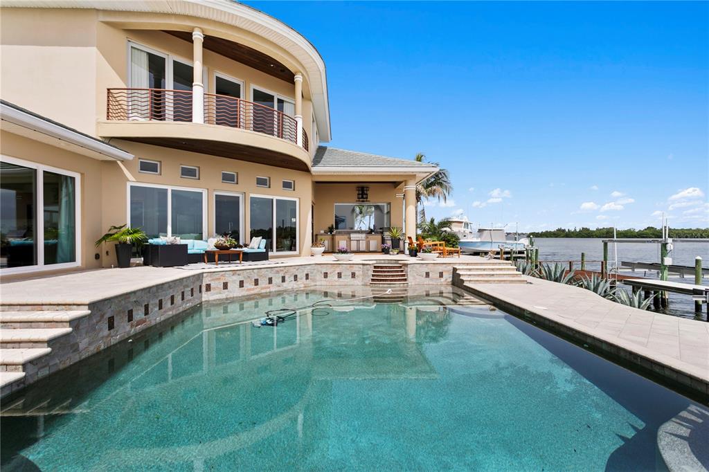 2279 Mermaid Point Northeast St. Petersburg, FL 33703 - Photo 51 of 100 a view of a swimming pool with couches chairs and a table