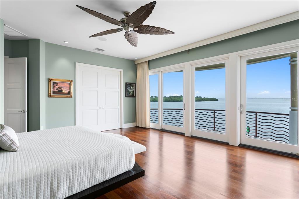 2279 Mermaid Point Northeast St. Petersburg, FL 33703 - Photo 70 of 100 a spacious bedroom with a balcony a bed and a desk