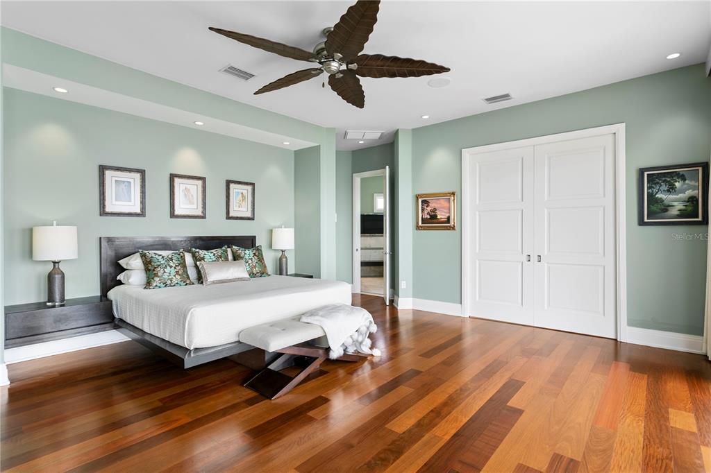 2279 Mermaid Point Northeast St. Petersburg, FL 33703 - Photo 71 of 100 a spacious bedroom with a bed and a chandelier