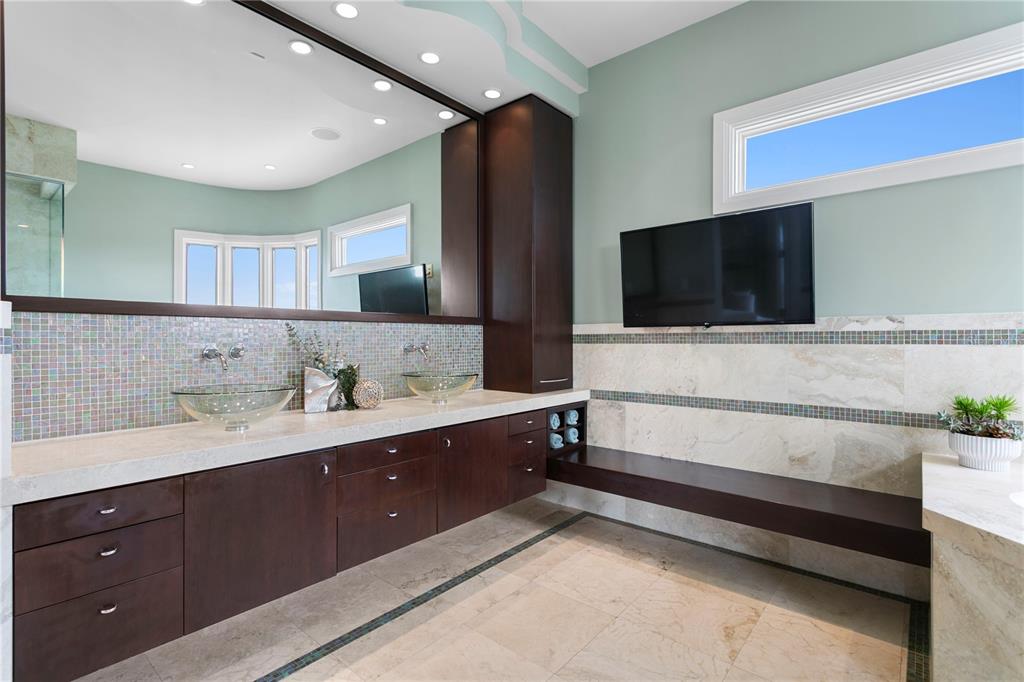 2279 Mermaid Point Northeast St. Petersburg, FL 33703 - Photo 75 of 100 a spacious bathroom with a double vanity sink and mirror