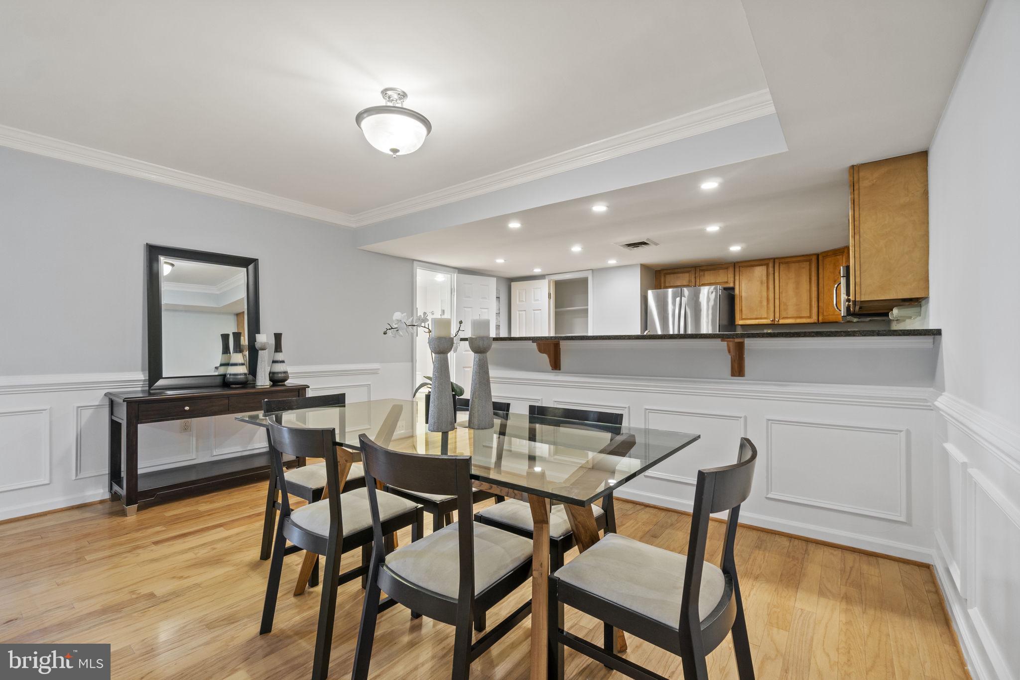 1515 South Arlington Ridge Road, Unit 603 Arlington, VA 22202 - Photo 3 of 22 a view of a dining room with furniture and wooden floor