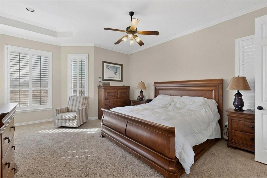 7625 Ridgedale Court Sachse, TX 75048 - Photo 16 of 40 AI,Bedroom with ornamental molding, light colored carpet, and a ceiling fan