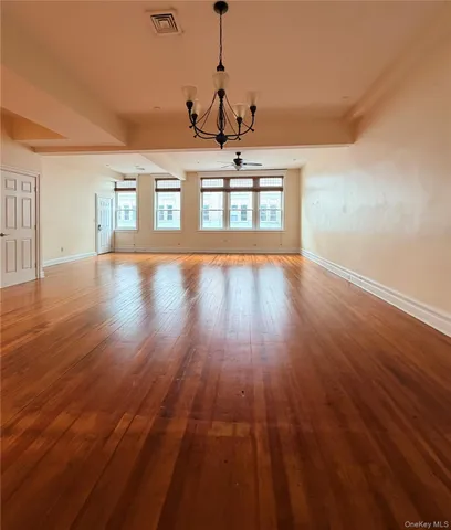 a view of a room with wooden floor and window
