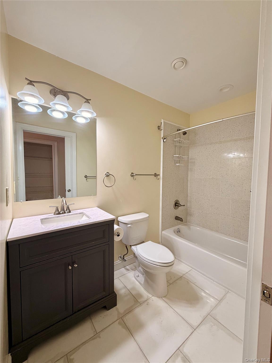 337 Main Street, Unit 2F Poughkeepsie, NY 12601 - Photo 12 of 25 a bathroom with a bathtub shower sink mirror vanity and toilet