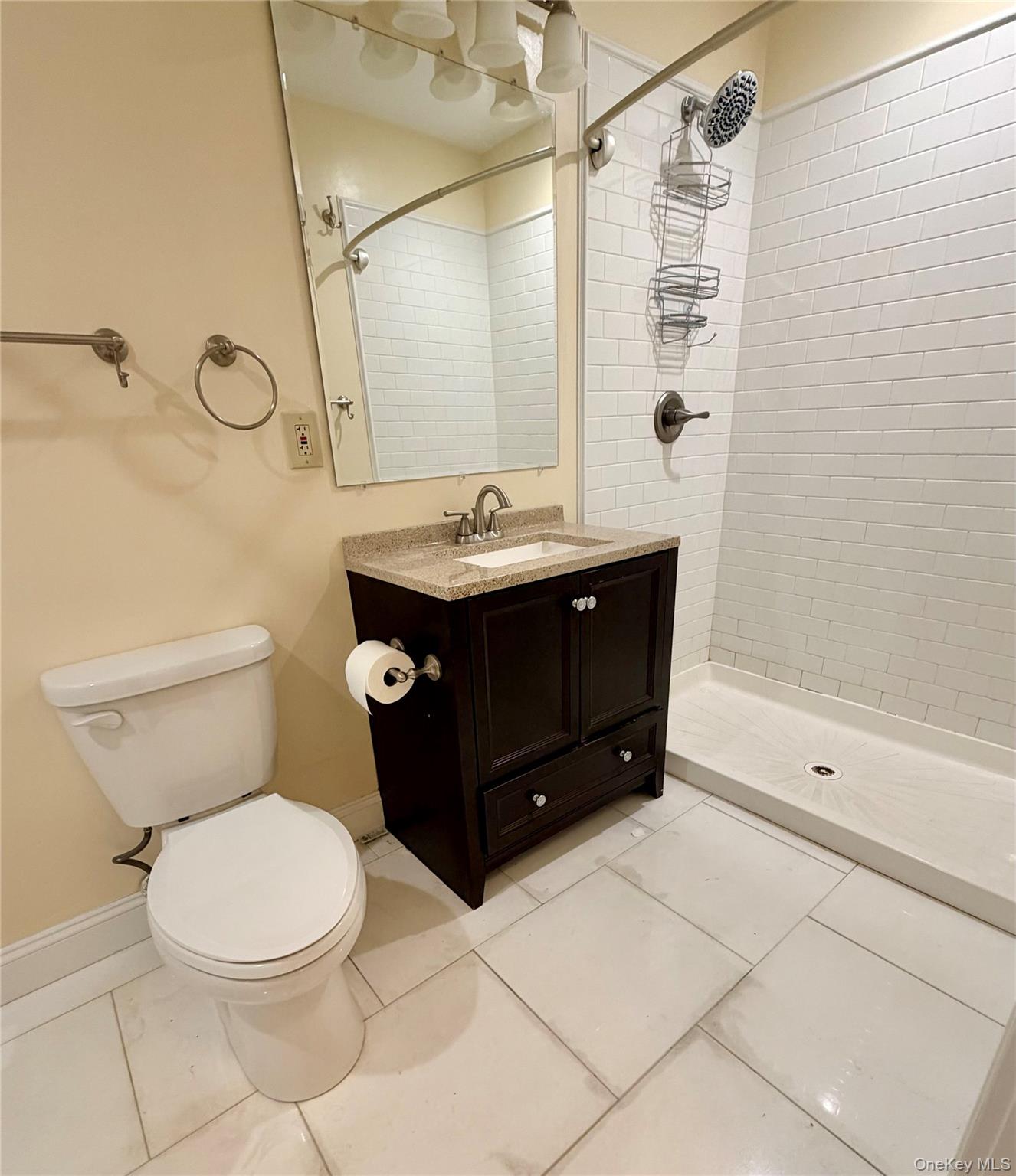 337 Main Street, Unit 2F Poughkeepsie, NY 12601 - Photo 16 of 25 a bathroom with a sink a toilet and shower