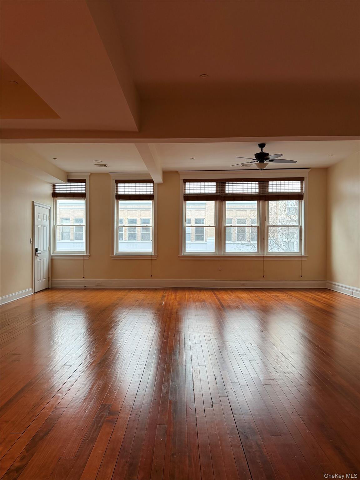 337 Main Street, Unit 2F Poughkeepsie, NY 12601 - Photo 5 of 25 a view of an empty room with wooden floor and a window