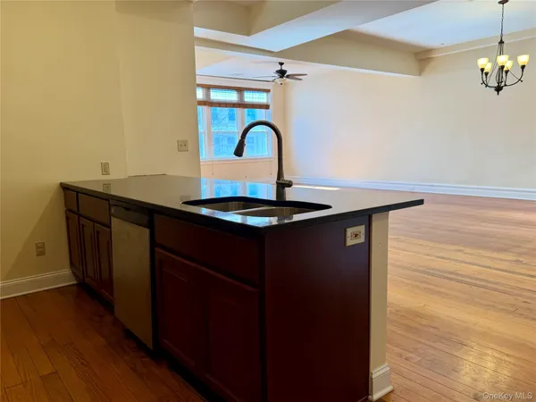 a large kitchen with stainless steel appliances granite countertop a refrigerator a stove top oven a sink and dishwasher