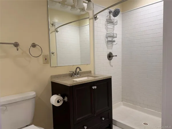 a view of a room with wooden floor and bench
