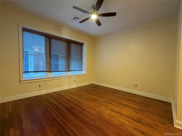 a bathroom with a bathtub shower sink mirror vanity and toilet