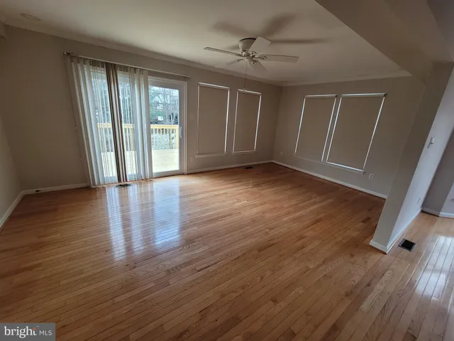 a view of an entryway with wooden floor and windows