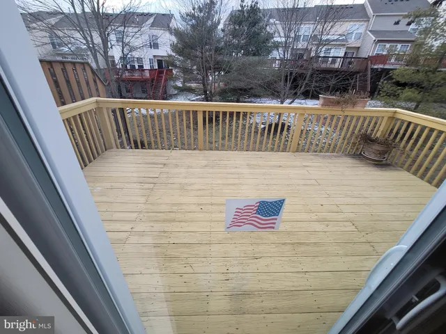 a front view of a building with lot of cars and trees