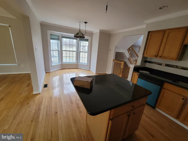 a living room with wooden floor furniture and a window