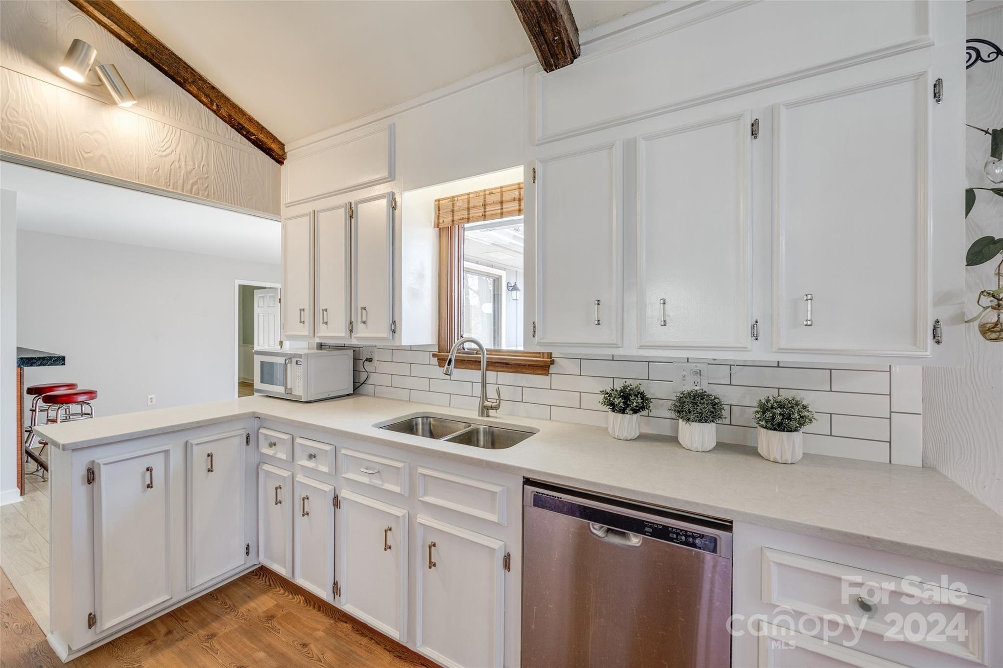 16039 Samoa Court Fort Mill, SC 29708 - Photo 11 of 30 a kitchen with white cabinets and sink