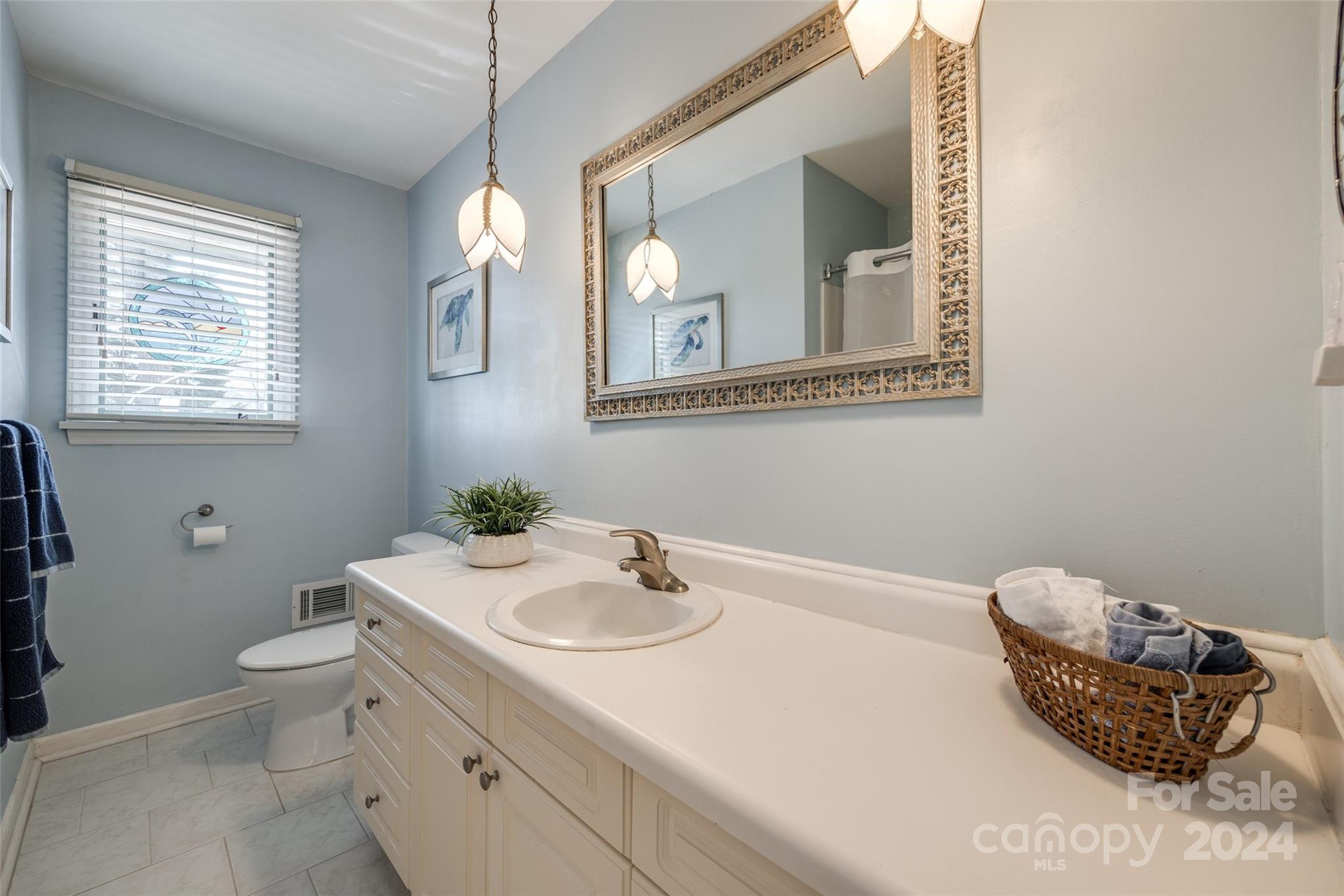16039 Samoa Court Fort Mill, SC 29708 - Photo 22 of 30 a bathroom with a toilet sink and mirror