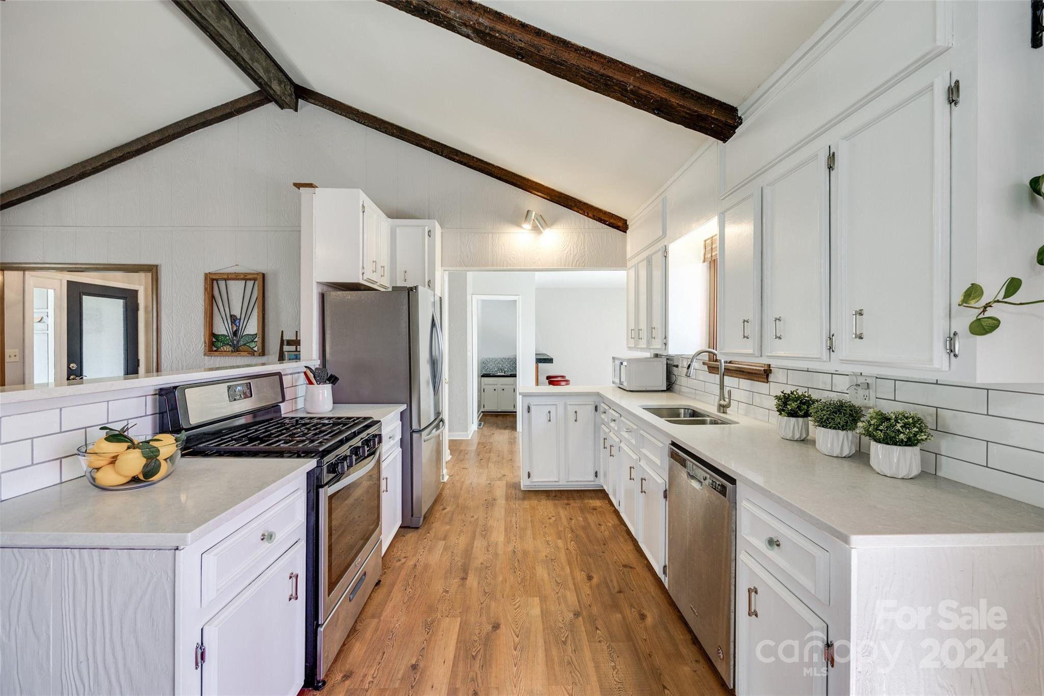 16039 Samoa Court Fort Mill, SC 29708 - Photo 9 of 30 a kitchen with stainless steel appliances granite countertop a sink a stove and cabinets